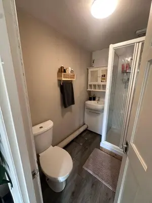 a small bathroom with a toilet and a shower at Birkdale Golf Open Holiday Home in Southport