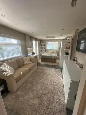 a living room with a couch and a bed at Birkdale Golf Open Holiday Home in Southport