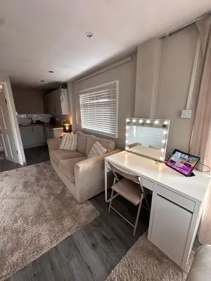 a living room with a desk and a couch at Birkdale Golf Open Holiday Home in Southport