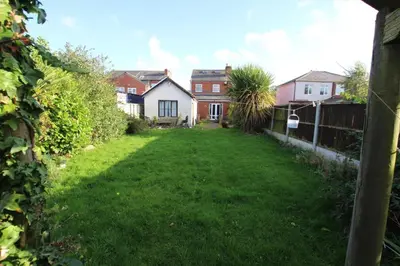an empty yard with houses and a fence at Birkdale Golf Open Holiday Home in Southport