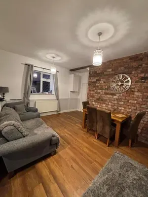 a living room with a couch and a table at Birkdale Golf Open Holiday Home in Southport