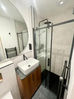 a bathroom with a sink and a shower at 2 Bedroom Apartments Near Anfield Stadium - Sleeps 4 per Flat in Liverpool