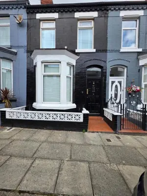 a house with a white front porch and a black door at 2 Bedroom Apartments Near Anfield Stadium - Sleeps 4 per Flat in Liverpool