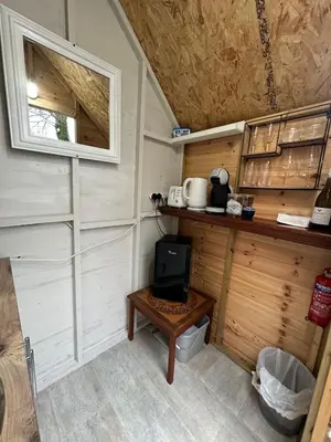 a small room with a tv and a table at The Telephone exchange very quaint hot tub stay in Scarisbrick