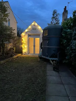a house with a garage with christmas lights on it at The Telephone exchange very quaint hot tub stay in Scarisbrick