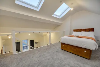 a bedroom with a bed in a room with skylights at Wigan - Apartment - Sleeps 6 - Parking in Wigan