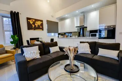 a living room with a couch and a glass table at Wigan - Apartment - Sleeps 6 - Parking in Wigan