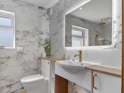 a white bathroom with a sink and a toilet at Newly Renovated Luxury Bungalow Pass the Keys in Ulverston