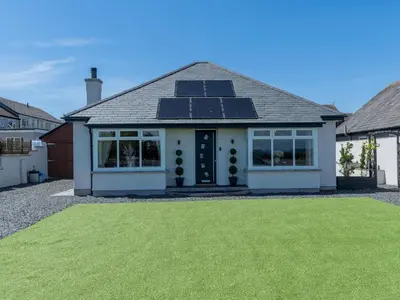 a house with solar panels on the roof at Newly Renovated Luxury Bungalow Pass the Keys in Ulverston
