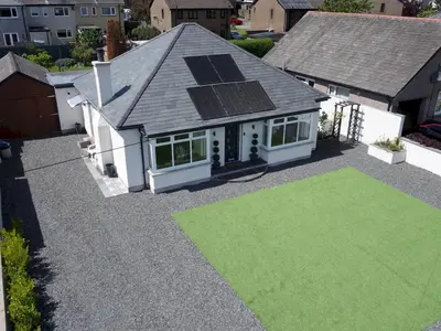 an aerial view of a house with a green lawn at Newly Renovated Luxury Bungalow Pass the Keys in Ulverston