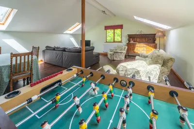a living room with a pool table with dolls on it at Leighton Banks in Beetham