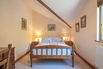 a bedroom with a bed and two night stands at Leighton Banks in Beetham