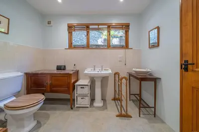 a bathroom with a toilet and a sink at Leighton Banks in Beetham