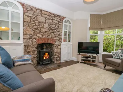 a living room with a stone wall with a fireplace at 28 Rock Villas in Carnforth