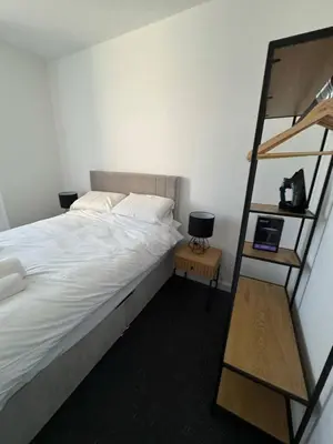 a bedroom with a bed and a book shelf at Homely stay Bootle Liverpool in Litherland