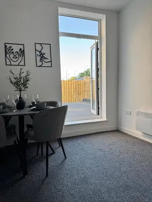 a dining room with a table and a window at Homely stay Bootle Liverpool in Litherland