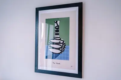 a picture of a hand holding a bottle in a picture frame at Elysée Suites - Modern 1 Bed Flat in Southport in Southport