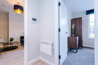 an open door to a living room with a radiator at Elysée Suites - Modern 1 Bed Flat in Southport in Southport