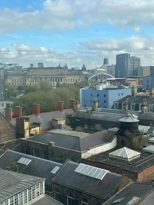 an aerial view of a city with buildings and roofs at City View One Bedroom Apartment by StaySavvy Accommodation in Liverpool