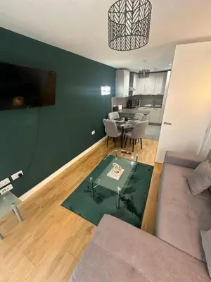 a living room with a couch and a table at City View One Bedroom Apartment by StaySavvy Accommodation in Liverpool