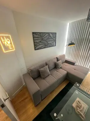 a living room with a couch and a table at City View One Bedroom Apartment by StaySavvy Accommodation in Liverpool