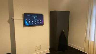 a room with a computer monitor on a wall at Olive Guest House in Bolton