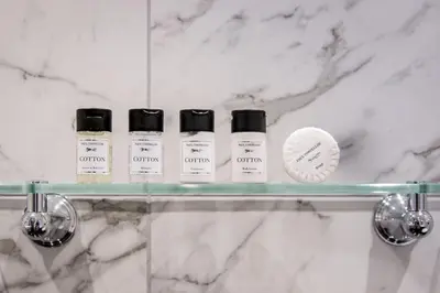 four bottles of essential oils on a glass shelf in a bathroom at Freemasons at Wiswell in Whalley