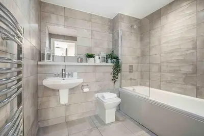 a bathroom with a sink and a toilet and a bath tub at GuestReady - Stylish Flat with Bay View in Liverpool