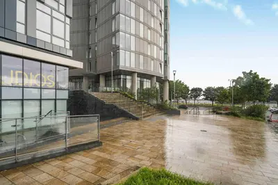 a wet sidewalk in front of a building at GuestReady - Stylish Flat with Bay View in Liverpool