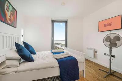 a living room with a couch and a window at GuestReady - Stylish Flat with Bay View in Liverpool
