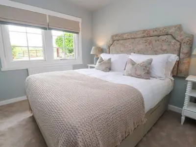a bedroom with a large bed and a window at Manor Lodge in Clitheroe