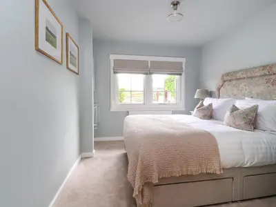a bedroom with a large bed and a window at Manor Lodge in Clitheroe