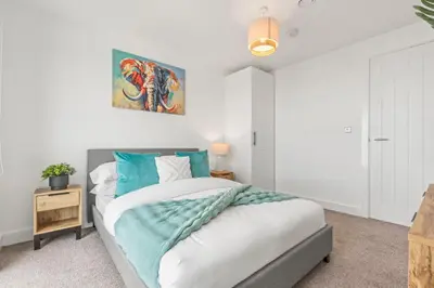 a bedroom with a large bed with blue pillows at Verona Apartment - City Apartment - 2Bed 2Bath in Liverpool