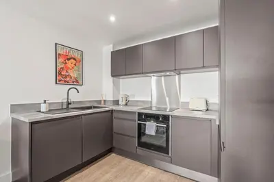 a kitchen with gray cabinets and a sink at Verona Apartment - City Apartment - 2Bed 2Bath in Liverpool