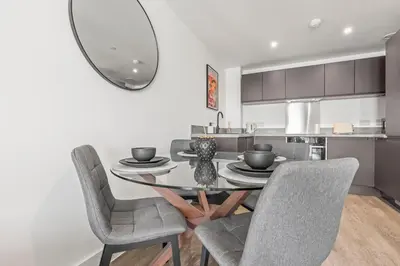 a dining room with a table with chairs and a mirror at Verona Apartment - City Apartment - 2Bed 2Bath in Liverpool