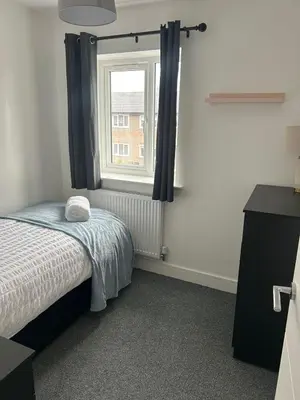 a small bedroom with a bed and a window at Spacious 4BR House with Backyard in Saint Helens in Saint Helens