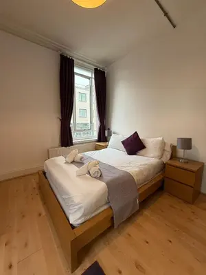 a bedroom with a large bed and a window at Large city centre apartment in Liverpool