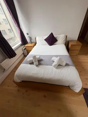 a bedroom with a bed with two towels on it at Large city centre apartment in Liverpool