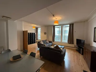 a living room with a couch and a table at Large city centre apartment in Liverpool