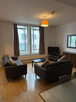 a living room with two couches and a television at Large city centre apartment in Liverpool