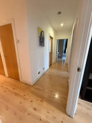 a hallway of a home with a hard wood floor at Large city centre apartment in Liverpool