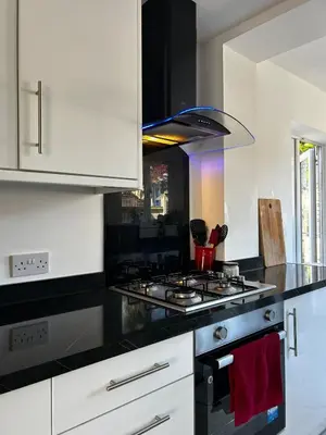 a kitchen with a stove and a stove top oven at Luxury 4 Bed Home Sleeps 9, Games Room, Parking