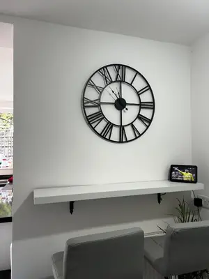 a black and white clock on a white wall at Luxury 4 Bed Home Sleeps 9, Games Room, Parking