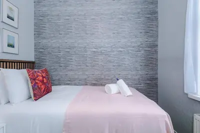 a bedroom with a bed with two towels on it at Stunning & Spacious Home by 53 Degrees Property, Sleeps 7 in the heart of Anfield! in Liverpool