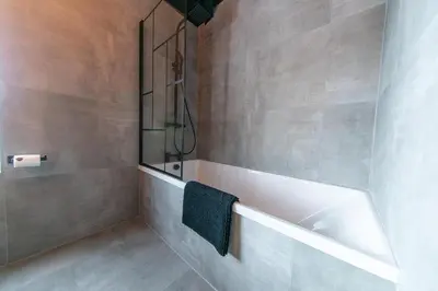 a bathroom with a bath tub and a sink at Villa Rose-Spacious Home with beautiful garden in Lytham St Annes