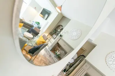 a view of a living room through a mirror at Villa Rose-Spacious Home with beautiful garden in Lytham St Annes