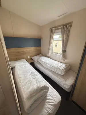 two beds in a small room with a window at Haven SAN 107 in Blackpool