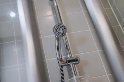 a shower with a shower head in a bathroom at Waterfront Penthouse with Balcony & Parking in Liverpool