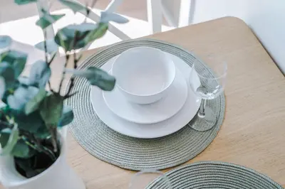 a table with a plate and a cup and a bowl and aucerurrencyangering at Waterfront Penthouse with Balcony & Parking in Liverpool