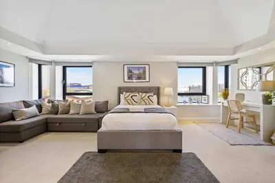 a living room with a bed and a couch at Waterfront Penthouse with Balcony & Parking in Liverpool